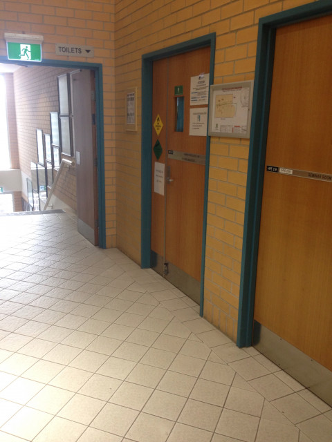 As you come in from the main entrance, just before the stairs