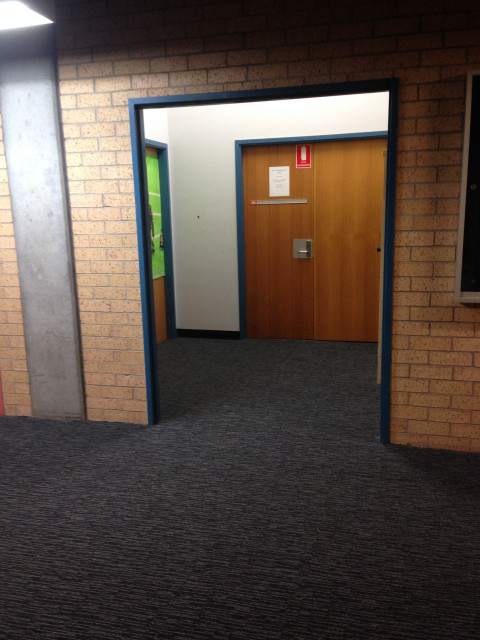 Come out of the elevator and walk straight through