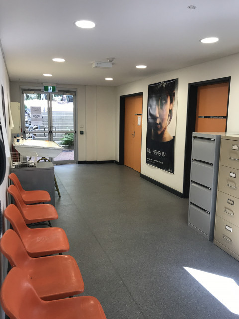 Corridor to the left at the bottom of the stairs