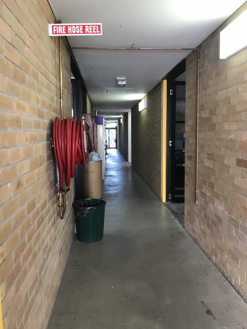 Corridor view from rear entrance. Room is second on the right