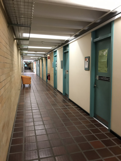 Corridor view looking towards Huxley disabled entrance. Staff offices along the right wall.