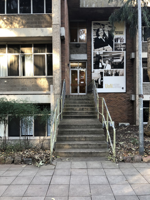Go up the stairs located behind the Newcastle Law School entrance
