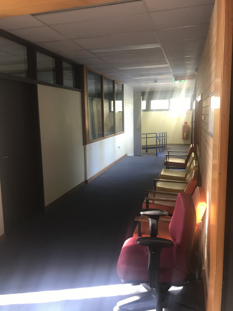 Right down this corridor. Turn left at the end, down the ramp